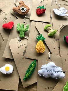 several different items are hanging from tags on a table with other things in the shape of clouds, sunflowers and teddy bears