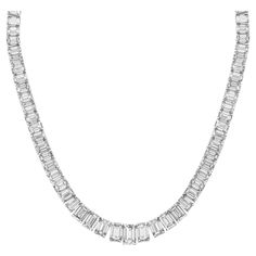 Elevate your elegance with our exquisite 19-inch Graduated Tennis Necklace, meticulously crafted in platinum and adorned with captivating emerald-cut diamonds. Each diamond is expertly set in a secure four-prong setting, showcasing their brilliance and clarity. The focal point of this masterpiece is the GIA certified H/SI2 emerald center, weighing 1.51 carats, radiating with unparalleled beauty and sophistication. With a total diamond weight of 30.04 carats, this necklace is a true statement of luxury and refinement. Indulge in timeless elegance with our Graduated Tennis Necklace, a symbol of enduring beauty and sophistication. Elegant Baguette Cut Emerald Necklace For Formal Occasions, Elegant Baguette Cut Emerald Necklace For Formal Events, Elegant Formal Baguette-cut Emerald Necklace, Formal Fine Jewelry Emerald Necklace With Baguette Cut, Luxury Silver Baguette-cut Diamond Necklace, Luxury Silver Baguette Cut Diamond Necklace, Formal Baguette Cut Emerald Necklace In Fine Jewelry Style, Formal Fine Jewelry Baguette Cut Emerald Necklace, Luxury Baguette Cut Emerald Necklace For Formal Occasions