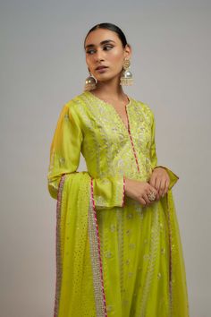 Editor's Note This anarkali, paired with a churidar and a beautiful chiffon badla dupatta, features flowing kalis down the waistline, adding a playful touch to the ensemble, perfect for any occasion. Designer Green Cotton Silk Anarkali Set, Green Cotton Silk Lehenga For Eid, Green Maxi Length Traditional Wear With Cutdana, Green Anarkali Cotton Silk Palazzo Set, Green Cotton Silk Anarkali Set For Festivals, Green Cutdana Anarkali Set For Navratri, Designer Green Cotton Silk Dupatta, Festival Cotton Silk Green Anarkali Set, Anarkali Dabka Sharara For Navratri