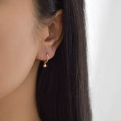 Sweet and dainty, these gold huggie earrings feature a polished round charm. Made of 14K gold filled materials, these earrings are tarnish-resistant, water-resistant, and hypoallergenic. Hoop measures 12mm in diameter while the charm measures 4mm in diameter. To put them on, don't pull the hoop apart, instead bend them towards opposite sides like shown in the photo. --------------------♥ PROMOS ♥-------------------- Want 10% off? Join the mailing list by visiting http://bit.ly/vedern . Just leav Huggie Plug Earrings As Gift, Everyday Dangle Hoop Earrings, Everyday Dangle Hoop Earrings For Pierced Ears, Delicate Everyday Pierced Earrings, Dainty Single Hoop Earring, Dainty Hoop Earrings With Ear Wire, Dainty Huggie Single Earring, Delicate Small Hoop Earrings With Ear Wire, Dainty Single Huggie Earring