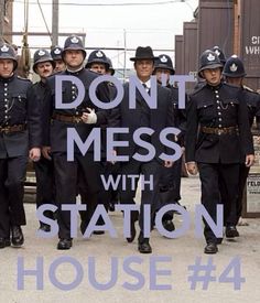 a group of uniformed men standing next to each other in front of a sign that says don't mess with station house 4