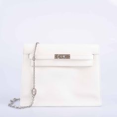 This Hermes Kelly Danse II, a 2023 creation, is a versatile marvel of the luxury world. This bag is a dance of elegance and adaptability, embodying Hermes' spirit of innovation and functionality. The lustrous White Evercolor Leather skin is a testament to refined taste, its smooth surface catching the light to reveal the depth and intricacy of the material. Complemented by the gleaming Palladium Hardware, this Kelly Danse II transitions seamlessly from day to night, from casual to formal. The beauty of the Kelly Danse lies in its versatility. It can be worn in multiple ways: slung casually over the shoulder, worn cross-body for hands-free ease, elegantly dangled from the wrist, or even styled as a chic belt bag or backpack. Each mode of wear redefines the bag's look, making it an indispens Practice Outfits, Kelly Bag, Leather Skin, One Design, Belt Bag, Fashion Forward, Shoulder Bag, Leather