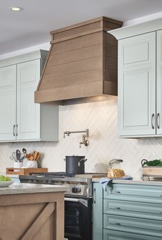 a kitchen with blue cabinets and an oven