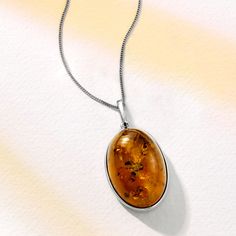 Ross-Simons - Oval Cognac Amber Pendant Necklace in Sterling Silver. 20". Connected to nature, this organic gemstone is absolutely stunning. Filled with vintage-style inspiration, a beautiful 30x20mm oval cognac amber cabochon dangles from a curb chain with a springring clasp. Set in polished sterling silver. Amber pendant necklace. Classic Amber Oval Cabochon Jewelry, Elegant Amber Oval Cabochon Necklace, Classic Oval Cabochon Necklace With Polished Finish, Oval Amber Cabochon Jewelry, Classic Oval Cabochon Necklace, Oval Jewelry With Natural Inclusions For Formal Occasions, Formal Oval Jewelry With Natural Inclusions, Formal Oval Amber Necklace, Vintage Oval Necklace With Polished Finish