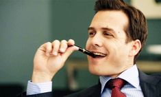 a man in a suit writing on a blackboard with the words good morning ladies