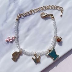 Mischievous Friends Beads Bracelet Introducing a delightful bracelet adorned with adorable character charms that celebrate the joy of friendship. This bracelet features a mischievous rabbit charm and a cheerful rabbit charm, symbolizing the playful bond between friends. Crafted with clear white beads that catch the sunlight and shimmer beautifully, this bracelet adds a touch of enchantment to your style. Wear this bracelet as a reminder of the special connections we share with our loved ones and Friendship Novelty Charm Bracelet, Cute Charm Bracelets For Friendship, Cute Beaded Bracelets With Charms For Gift, Friendship Themed Charm Bracelet, Adjustable Bracelets With Removable Charms For Friendship, Cute Adjustable Charm Bracelet, Adjustable Charm Bracelet With Dangling Charms For Friendship, Handmade Themed Charm Bracelet For Friendship, Adjustable Friendship Charm Bracelet With Dangling Charms