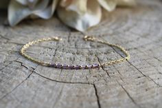 Beautiful crystals are combined with a dainty chain to create this beautiful bracelet.  Amethyst has been renowned for its beauty throughout the ages and is also the birthstone for anyone born in the month of February. D E T A I L S  *It features micro- faceted Brazilian amethyst gemstones - separated by seamless gold filled beads. *Beads measure around 2mm and originate from  *Choose between and 18k gold filled chain, rose gold filled or 925 sterling silver chain. *Gold filled is a wonderful al Dainty Amethyst Jewelry With Adjustable Chain, Elegant Purple Birthstone Beaded Bracelets, Dainty Amethyst Bracelet Jewelry, Dainty Amethyst Jewelry With Delicate Chain, Dainty Faceted Amethyst Jewelry, Dainty Gold Amethyst Bracelets, Elegant Purple Chain Bracelet As Gift, Dainty Amethyst Bracelets For Gift, Dainty Purple Gemstone Bracelets