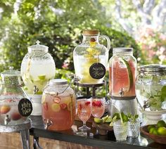 a table topped with lots of different types of drinks