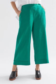 Product Details Linen culotte. Made from 100% French linen, the Vassa Culotte features a flat front waistband, angled front pockets and faux cuff detail for a casually tailored look. Elasticated at the back of the waist for comfort, this slightly cropped pant also has an internal tie to adjust the waist to fit. Easy, pull-on style with an elastic back waistband Tie in the internal front waistband Wide leg with an exaggerated faux cuff detail Crafted from 100% French linen Similar cut to our popu Aloe Green, Regions Of France, Garment Factory, Natural Fibre, Cuff Detail, Great Team, French Linen, Small Crossbody Bag, Small Crossbody