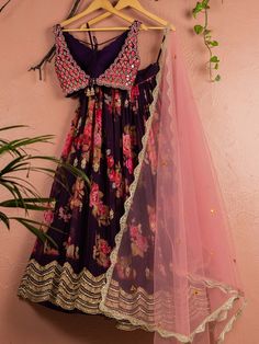 A three-piece violet floral mirror lehenga set with light pink dupatta from the Anisha Shetty collection. This beautiful violet floral printed georgette lehenga is paired with a mirror blouse in raw silk fabric. The lehenga set is enhanced with heavy abla embroidery work with the beautiful floral print. The V neck mirror blouse has scalloped edging all over with a sequin tassel tie-up at the back. This outfit is completed with a light pink net dupatta with heavy embroidery scalloped edging. Royal Blue Lehenga, Raw Silk Lehenga, Floral Mirror, Raw Silk Fabric, Green Lehenga, Blue Lehenga, Pink Lehenga, Wedding Branding, Net Dupatta