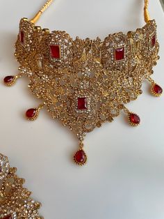 Traditional Gold Choker with detailed work and beautiful stones to upgrade any outfit! Perfect for Bridal wear! It comes as a full set in 2 colors to go for any outfit! Elegant Festive Choli With Intricate Design, Elegant Kundan Formal Sets, Festive Kundan Embellished Sets, Elegant Kundan Sets For Formal Occasions, Festive Embellished Kundan Sets, Bollywood Choli With Intricate Design For Festive Occasions, Elegant Stone Work Choli For Festivals, Festive Elegant Lehenga With Stone Work, Elegant Choli With Stone Work For Festivals