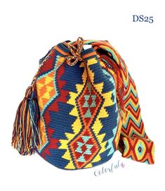 a multicolored woven bag with tassels