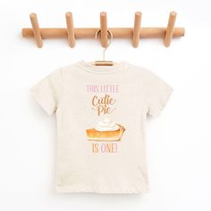 Cutie Pie Fall First Birthday shirt, Our Little Cutie Pie is Turning One shirt,  Pumpkin Pie Shirt, Pumpkin Birthday, Matching Family Shirts Welcome to Christi Creations! Here you will find that unique outfit for a special birthday! We have been in business over 14yrs here on Etsy and can assure you that you will receive 5 Star service! Thank you for supporting our small family business:) "Cutie Pie" birthday collection. Matching family members also available. If you are looking for a particular Casual Pre-shrunk T-shirt For First Birthday, Cute Cotton T-shirt For Birthday, Graphic Tee For First Birthday With Short Sleeves, Cute Tops With Funny Print For First Birthday, Casual Crew Neck Top For First Birthday, Casual T-shirt With Funny Print For First Birthday, Cute Letter Print Top For First Birthday, Cute Crew Neck T-shirt For Birthday, Cute Crew Neck Top For Birthday