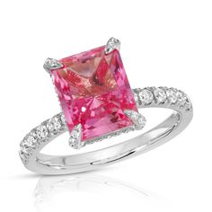 The radiant cut, cultured pink sapphire at the center of this playful ring represents the color of fiery passion for love and for life. A moissanite hidden halo and encrusted prongs offer just the right amount of sparkle to this feminine and charming ring. Made to order. Please allow 6-8 weeks for delivery.DETAILS:Center Stone: Type: Pink Sapphire (cultured) Size: 8 x 10mm (3.5ct diamond equivalent) Color: Pink Cut: Radiant Setting: Moissanite hidden halo and encrusted prongs 10K, 14K or 18K sol Radiant Cut Sapphire Ring With Accent Stones, Pink Emerald Cut Ruby Ring In Fine Jewelry, Emerald Cut Pink Ruby Ring In Fine Jewelry Style, Dazzling Pink Emerald Cut Ring, Radiant Cut Sapphire Promise Ring, Radiant Cut Sapphire Ring With Prong Setting, Pink Emerald Cut Sapphire Ring In Fine Jewelry Style, Fine Jewelry Pink Emerald-cut Sapphire Ring, Fine Jewelry Pink Sapphire Ring With Emerald Cut