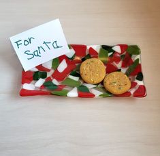 two cookies on a red and white plate with a sign that says for safter