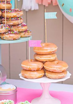 there are many doughnuts on the table and one has a happy birthday sign