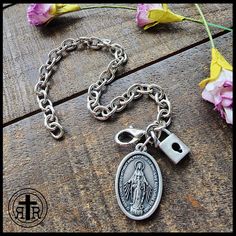 We are proud to offer this women's Consecration to Mary bracelet at such an affordable price. Our version has Our Lady's Miraculous Medal and a small Lock to remind you of your devotion. Antique Silver medal Chain Sturdy lobster clasp. Fits up to size 8.25 inches. Official Act of Consecration to Mary (DOWNLOAD a printable version HERE) Written by St. Maximilian Kolbe O Immaculata, Queen of Heaven and earth, refuge of sinners and our most loving Mother, God has willed to entrust the entire order Queen Of Heaven And Earth, Combat Rosary, Rugged Rosary, St Maximilian Kolbe, Maximilian Kolbe, Black Monks, St Maximilian, Paracord Rosary, Chain Bracelet For Women