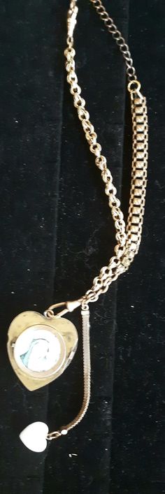 Antique Gold filled watch Fob assemblage necklace Created using 12 karat gold filled watch fob / chains 1940s Pendant is a Rose Gold filled partial Locket with Mother Mary on one side ,encased in Glass . Seed pearls & a Ruby or Garnet stone on the other! * There was a missing Seed Pearl in the half locket that was replaced by a bead. Another Gold -filled fob dangles beside , with a genuine mother-of-pearl Heart, vintage piece. I fell in LOVE with this piece, and have never seen another like Antique Curb Chain Necklace, Antique Curb Chain Necklace With Oval Links, Victorian Necklace With Oval Link Curb Chain, Victorian Yellow Gold Curb Chain Necklace, Victorian Yellow Gold Necklace With Curb Chain, Antique Formal Chain Necklaces, Antique Heart Pendant Necklaces With Vintage Charm, Antique Jewelry With Oval Link Curb Chain, Antique Heart Pendant Necklace With Vintage Charm