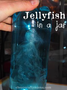 jellyfish in a jar being held up by someone's hand with the caption jellyfish in a jar