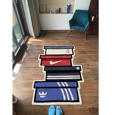 a pair of blue shoes sitting on top of a wooden floor next to a pile of books