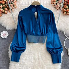 Stand collar, hollow out, short style, hot drill, satin shirt with bubble sleeve, fashionable short style topMaterial:satinColor:white,black,blue,redStyle:stylishFeature:bubble sleeve,stylishSize(CM):free 1inch=2.54cmlength:44,bust:94,sleeve:62&ltp&gtAll items will arrive in about 20-25 business days, if you have an emergency, please contact us to upgrade logistics.</p>&ltbr/>&ltp&gtNeed to add 16 dollars fast shipping(Arrive in 10-14 days).</p>&ltbr/> Blue Long Sleeve Satin Top, Blue Satin Long Sleeve Top, Trendy Satin Top For Parties, Satin Padded Blouse For Night Out, Padded Satin Blouse For Night Out, Blue Satin Party Blouse, Trendy Fitted Satin Blouse, Trendy Long Sleeve Satin Tops, Chic Tops Blouses