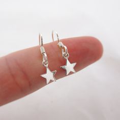 SOLID STERLING SILVER EARRINGS These celestial earrings make a wonderful gift. The real sterling silver ear hooks are adorned with a tiny star (also 925 sterling silver). Comes in a gift box, perfect for gift giving. Total earring length is just under 1 inch long.  STAR CHARM: Please note that the star charms are TINY. Their dainty size measures approximately 1/4 inch tall.  ALSO AVAILABLE IN A MOON DESIGN OR MOON/STAR COMBO Silver Moon Earrings, Sterling Silver Star Earrings, Star Dangle Earrings, Silver Star Earrings, Celestial Earrings, Moon And Star Earrings, Turquoise Bead Necklaces, Tiny Star, Turquoise Rings