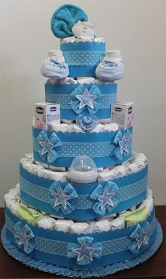 a three tiered blue and white diaper cake with snowflakes on it