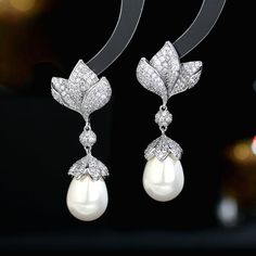 Formal Cubic Zirconia Flower Drop Earrings, Formal Dangle Flower Earrings With Cubic Zirconia, Elegant Pearl Embellished Cubic Zirconia Earrings, Luxury Diamond White Flower Earrings For Wedding, Elegant Diamond Flower Earrings For Wedding, Elegant Diamond Bridal Earrings With Pearl Drop, Elegant Diamond White Pearl Bridal Earrings, Elegant Cubic Zirconia Flower Earrings, Elegant Pearl Earrings With Diamond