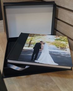 an open box with a wedding photo in it