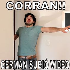 a man standing in front of a white wall holding a nintendo wii game controller with the words cofran on it