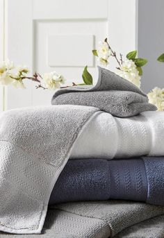 towels stacked on top of each other with flowers in the background