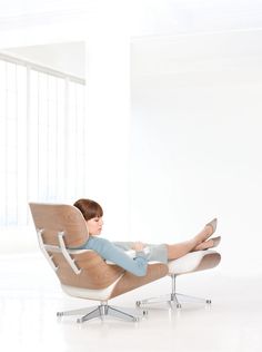 a young boy sitting in a chair with his feet up