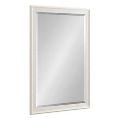 a white framed mirror on a wall