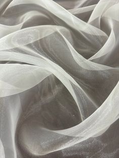 an image of white fabric that is blowing in the wind