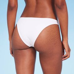 Add a versatile swim separate to your beach-ready closet with this High Leg Extra-Cheeky Bikini Bottom from Shade & Shore™. Made from soft fabric with spandex and full lining for stretchy comfort in and out of the water, this solid-color bikini bottom is designed with a low rise and high leg. The extra-cheeky cut lends you a flattering fit, while the opaque construction offers plenty of coverage for confident wear. Shade & Shore™: Found exclusively at Target. Fitted Swim Skirt For Vacation, Seamless Nylon Swimwear For Sunbathing, Stretch Bottoms For Sunbathing On Vacation, Seamless Summer Bottoms For Beach, Beachy Seamless Swimwear For Beach Party, Beachy Stretch Tankini, White Seamless Swimwear For Beach, White Fitted Swim Trunks For Surfing, Lightweight White Swimwear For Poolside