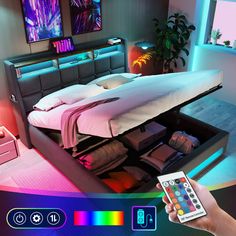 a person holding a remote control in front of a bed with an illuminated headboard