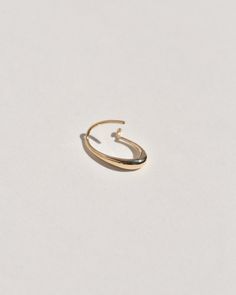 A semi-permanent style, the Sempre Hoop is part of a new offering of Leigh Miller that is designed to be worn everyday- or 'sempre'- which means always in Portuguese and Italian. This sculptural, solid gold hoop is intended to be put in, and never taken off. Wear it in the shower, in the pool or to sleep. Simply slide it in and fold the arm into its hook. Leigh was inspired to design this series to be the perfect huggers to compliment the rest of our sculptural earrings. The Sempre is ideal for Minimalist Oval Hoop Earrings For Anniversary, Modern 14k Gold Oval Hoop Earrings, Modern Oval 14k Gold Hoop Earrings, Oval 14k Gold Hoop Earrings Timeless Style, 14k Gold Oval Hoop Earrings Timeless Style, Modern Yellow Gold Oval Link Hoop Earrings, Timeless Oval 14k Gold Hoop Earrings, Timeless 14k Gold Oval Hoop Earrings, 14k White Gold Oval Hoop Earrings