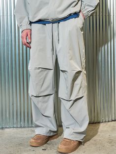 Editor's notesIt is a casual parachute pant for unisex. Made of dense heavyweight nylon spandex fabric  the pant is waterproof and has comfy fit. The pant has parachute design point on the front and double stitching for durable finish. The silhouette of the pant is adjustable using drawcords on the hem. - Elastic waist with drawstring- Side pockets- Patched back pocket- Spandex blend fabricMeasurements(in.)Size 1 / Size 2- Length: 39.8 in. / 40.9 in.- Waist: 13.8 in. / 14.2 in.- Thigh: 13 i Urban Style Baggy Parachute Pants For Outdoor, Urban Parachute Pants For Outdoor, Nylon Parachute Pants For Streetwear Techwear Style, Functional Khaki Parachute Pants For Streetwear, Baggy Solid Parachute Pants For Outdoor, Functional Nylon Parachute Pants For Outdoor, Nylon Techwear Parachute Pants For Outdoor Activities, Nylon Techwear Parachute Pants For Outdoor, Urban Nylon Parachute Pants For Outdoor