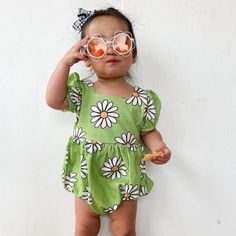 The green daisy romper is the perfect vintage-inspired piece for your little girl. Featuring a cool daisy print on a cheery green background, a square neckline, and cute puff sleeves, your little one will be irresistibly cute in this nostalgic romper. Not only will they look absolutely cute in this timeless piece, they will be so comfortable since it's made from a stretchy cotton spandex blend material. What's better than sweet vintage style with modern comfort for a little one? Cute Short Sleeve Bubble Romper For Spring, Spring Cute Short Sleeve Bubble Romper, Cute Floral Print Bubble Romper For Playtime, Cute Green Bubble Romper For Playtime, Cute Summer Floral Print Bubble Romper, Playful Floral Print Bubble Romper For Spring, Spring Playful Floral Print Bubble Romper, Playful Fitted Short Sleeve Jumpsuits And Rompers, Playful Fitted Short Sleeve Jumpsuit