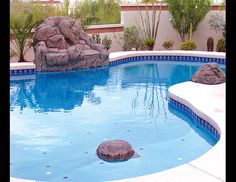 an empty swimming pool with rocks in it