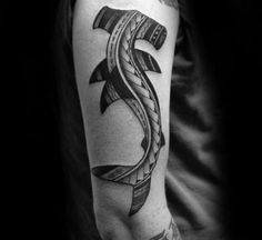 a black and white photo of a man's arm with an anchor tattoo on it