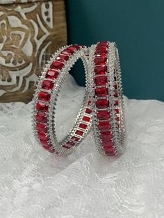 American diamond bangle/bracelet in Silver . About one inch wide. Colored stone work Cubic Zirconia Bangle Bracelet For Gift, Crystal Bangle Bracelets As Gift, Stackable Fusion Style Bangle Bracelets, Elegant Jeweled Hoop Jewelry, Stackable Diamond Cuff Bracelet Bangle, Stackable Diamond Cuff Bangle Bracelet, Red Round Bracelets With Diamond Accents, Festive Gemstone Bangle Bracelets, Red Bracelets With Diamond Accents