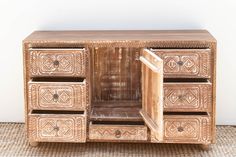 an ornate wooden cabinet with drawers and doors