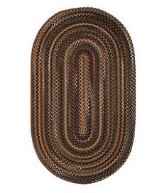 an oval rug is shown in brown and tan