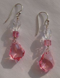 Sweetheart pink crystals and clear crystals. Sterling Silver Ear wires. Teardrop, square and shield shapes. One of a kind earrings. Please Note: The color in the video is muted. The actual color of the pink crystals is like the other photos. Affordable Pink Wire Wrapped Earrings, Cheap Handmade Pink Crystal Earrings, Pink Crystal Earrings For Pierced Ears, Pink Crystal Dangle Earrings With Ear Wire, Handmade Pink Crystal Earrings In Sterling Silver, Handmade Pink Crystal Sterling Silver Earrings, Pink Crystal Drop Earrings, Handmade Pink Crystal Earrings, Pink Sterling Silver Drop Crystal Earrings