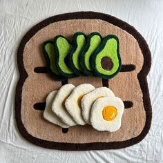 an egg, avocado and toast on a mat