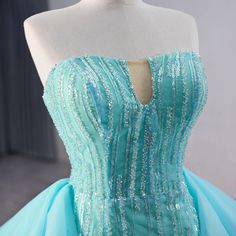 a dress on a mannequin with sequins and beading in blue