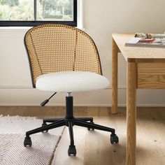 an office chair sitting on top of a wooden floor next to a desk with a window