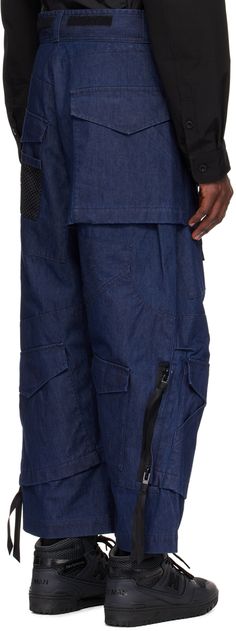 Non-stretch chambray jeans. Flap pockets throughout. · Paneled construction · Belt loops · Velcro detailing at waistband · Zip-fly · Mesh pocket at front and back leg · Tucks at knees · Two-way zip detailing at outseams · Bonded nylon taffeta lining Part of the Junya Watanabe MAN collection. Supplier color: Indigo Baggy Indigo Jeans With Pockets, Baggy Indigo Bottoms With Pockets, Utility Denim Pants With Hip Pockets, Denim Cargo Pants With Dark Wash, Denim Cargo Pants With Belt Loops In Dark Wash, Urban Style Dark Wash Cargo Pants With Hip Pockets, Medium Wash Utility Pants With Hip Pockets, Urban Style Dark Wash Cargo Pants With Belt Loops, Urban Style Dark Wash Cargo Pants