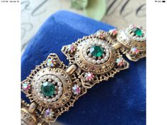 "Vintage Ornate AB Emerald Green Rhinestones Statements Wrist Bracelet This lovely piece can be worn on any occasion and is absolutely beautiful in the light, both inside and out, the perfect gift for anyone who loves vintage jewelry. Colors and Shades may vary due to Lighting - Measures Approx. 7\" - Each order comes shipped in a small drawstring pouch, all ready for gifting. -If you are wanting to have this mailed as a gift to a special someone, please write their address in the note section, Bohemian Jeweled Bracelets For Wedding, Bohemian Jeweled Wedding Bracelets, Bohemian Jeweled Bracelets For Formal Occasions, Bohemian Jeweled Bracelet For Formal Occasions, Vintage Bling Bracelets As Gifts, Costume Jewelry Bracelets With Bling For Gifts, Costume Jewelry Bling Bracelets For Gift, Bling Costume Jewelry Bracelets As Gift, Jeweled Round Crystal Bracelet As Gift